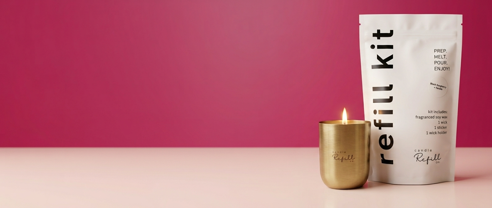 A refill kit candle product shown with a white pouch labeled 'refill kit' and a small gold candle holder with a lit candle, set against a pink and beige studio background.
